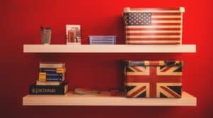 Shelf with UK and US flag boxes on it and a dictionary