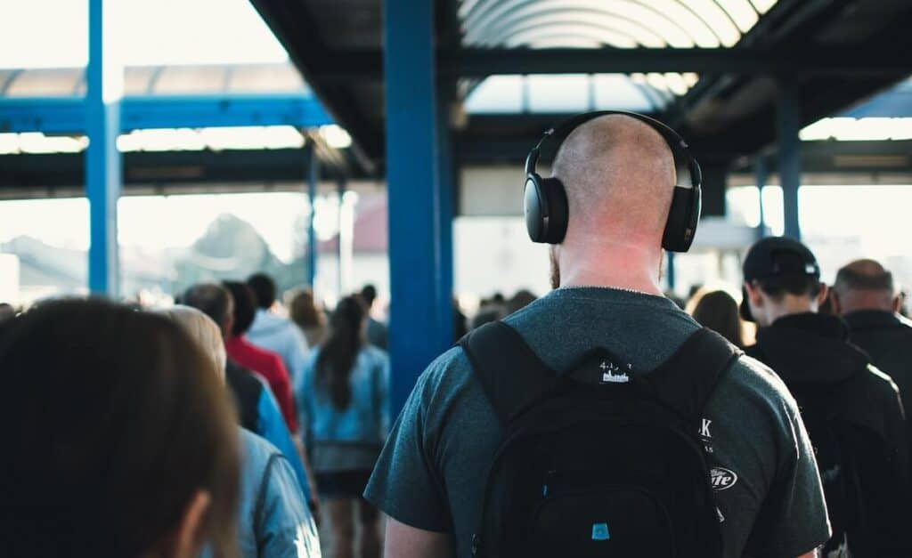 Man listening to a podcast on headphones on his commute