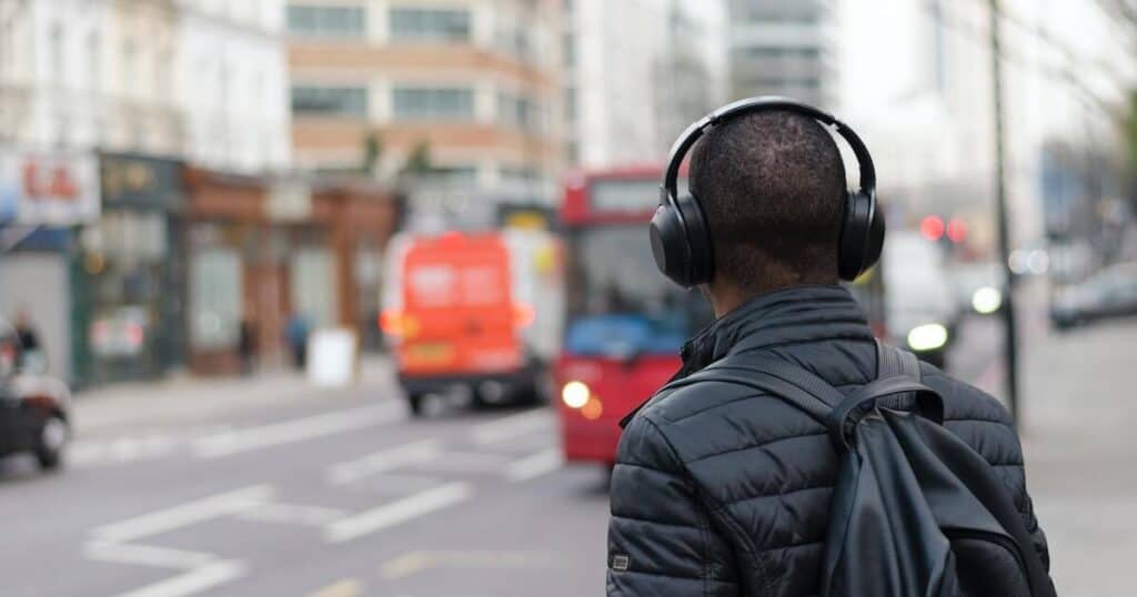 Man on London street listening to audio content
